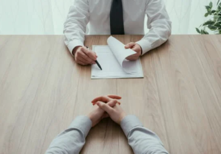 A man is interviewing someone on the table